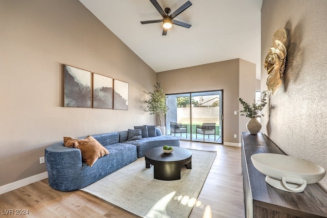 living room with high vaulted ceiling, ceiling fan, and hardwood / wood-style flooring