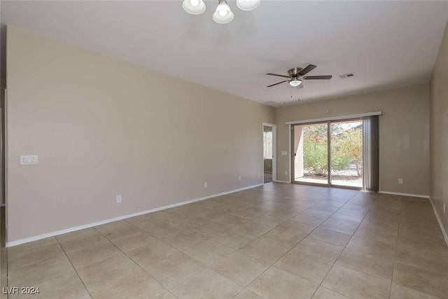 tiled empty room with ceiling fan