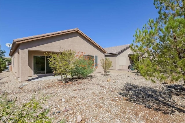 rear view of property featuring a patio