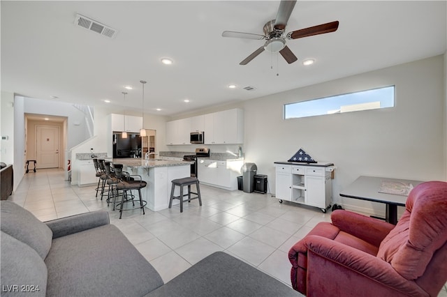 tiled living room with ceiling fan