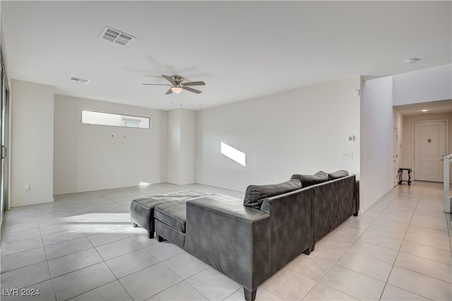 tiled living room featuring ceiling fan