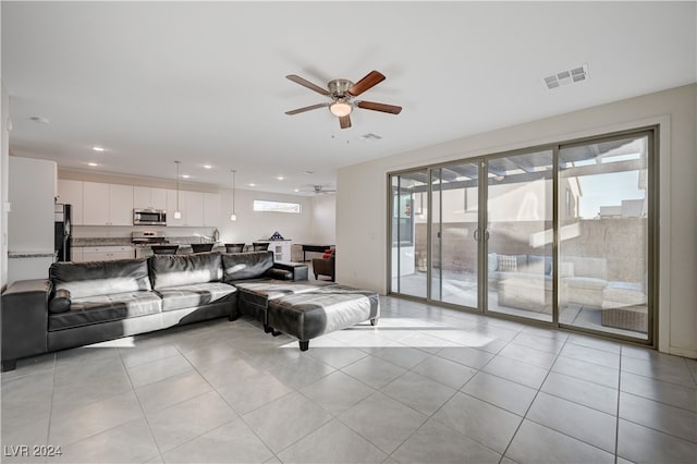 living room featuring light tile patterned floors and ceiling fan