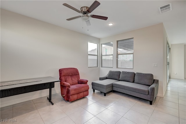 living room with ceiling fan and light tile patterned flooring