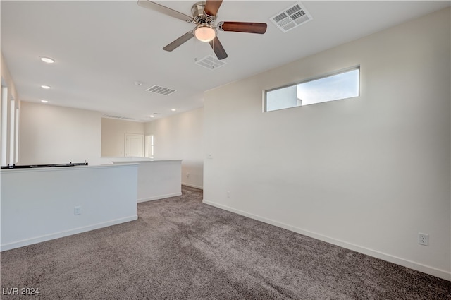 empty room featuring carpet flooring and ceiling fan