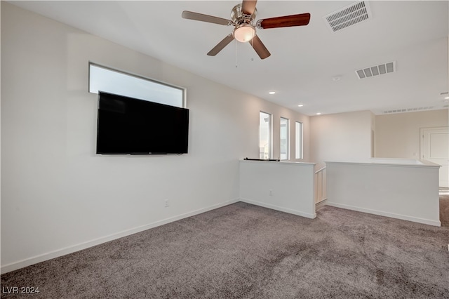 unfurnished living room featuring ceiling fan and carpet floors