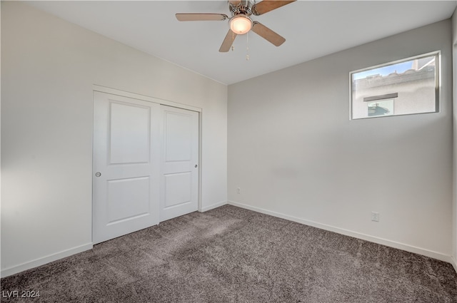 unfurnished bedroom featuring carpet flooring, ceiling fan, and a closet