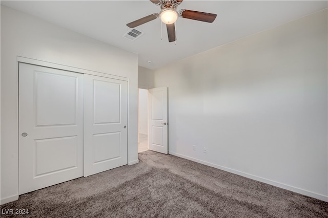 unfurnished bedroom featuring ceiling fan, a closet, and carpet floors