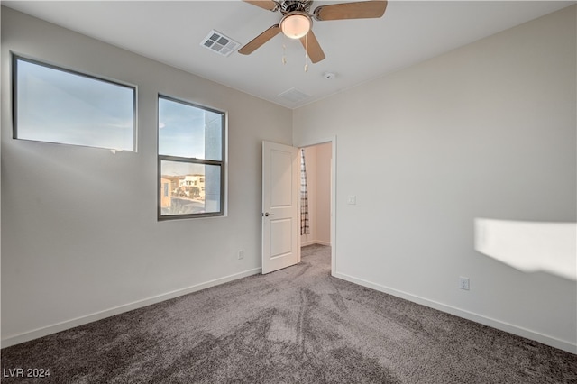 carpeted empty room featuring ceiling fan