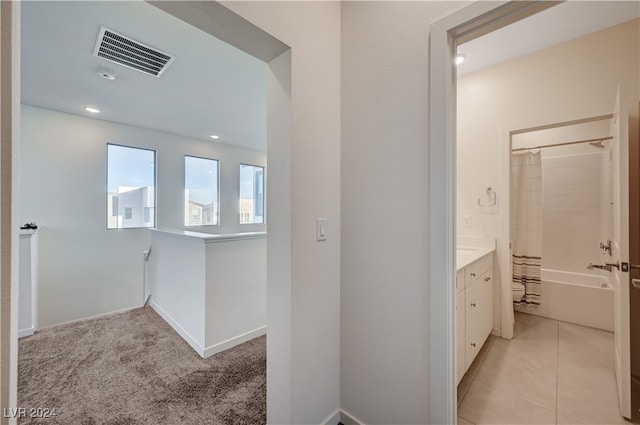 hallway featuring light colored carpet