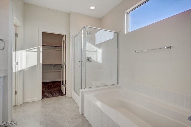 bathroom featuring tile patterned flooring and shower with separate bathtub