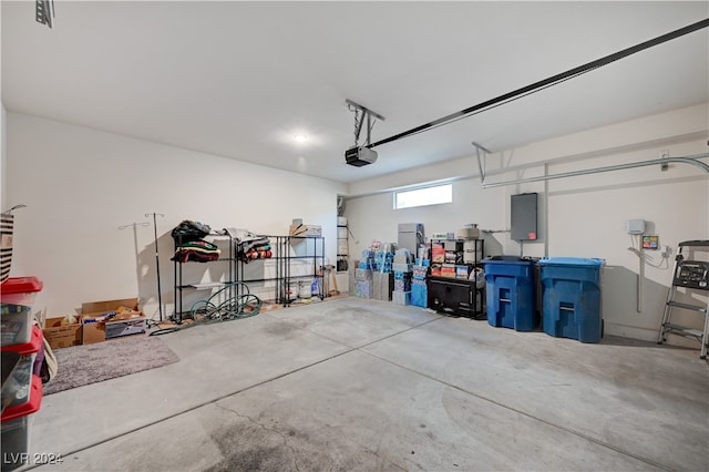 garage featuring electric panel and a garage door opener