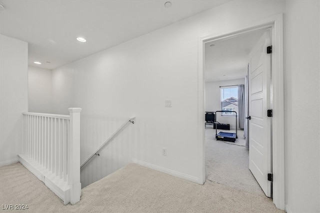 hallway featuring light carpet