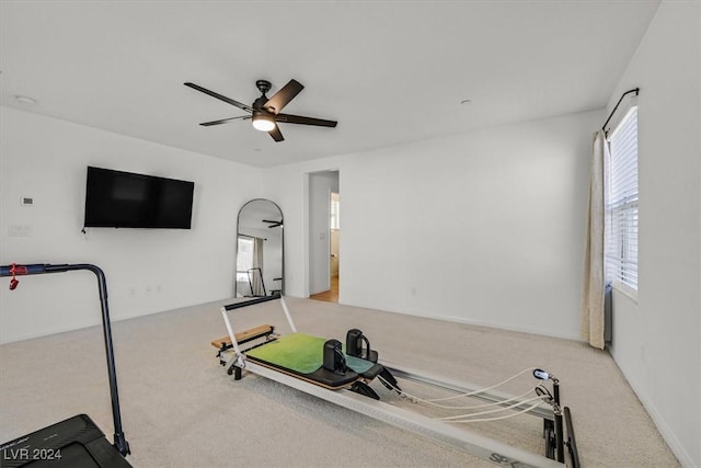 workout area with light colored carpet and ceiling fan