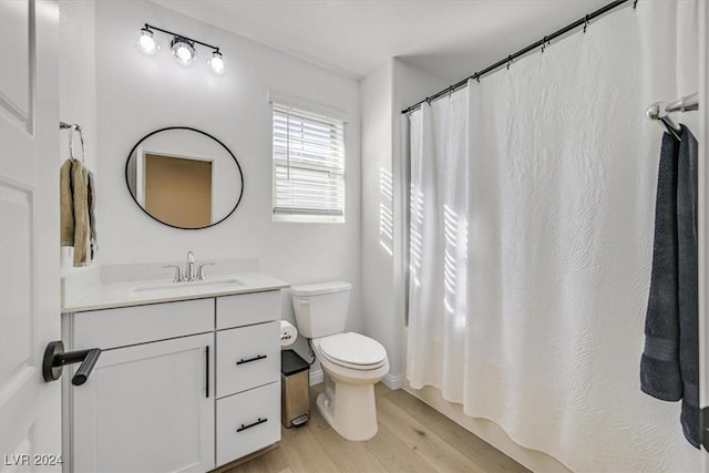 bathroom featuring hardwood / wood-style floors, vanity, and toilet