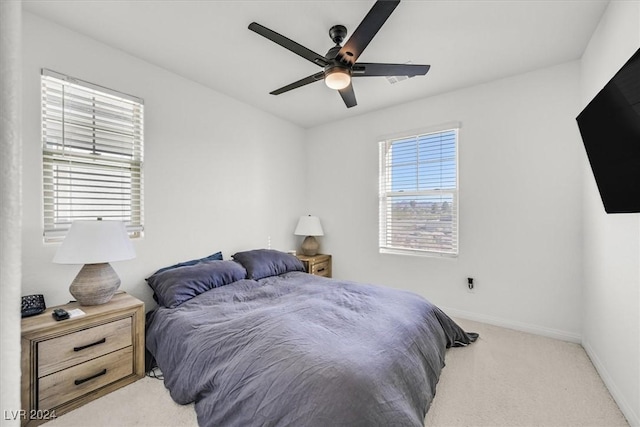 bedroom with ceiling fan and light carpet