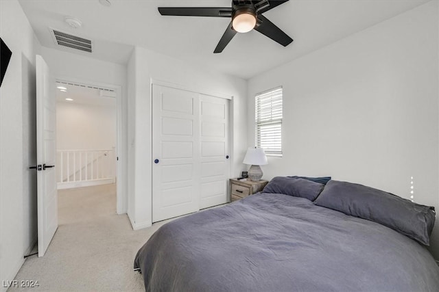 bedroom with ceiling fan and light colored carpet