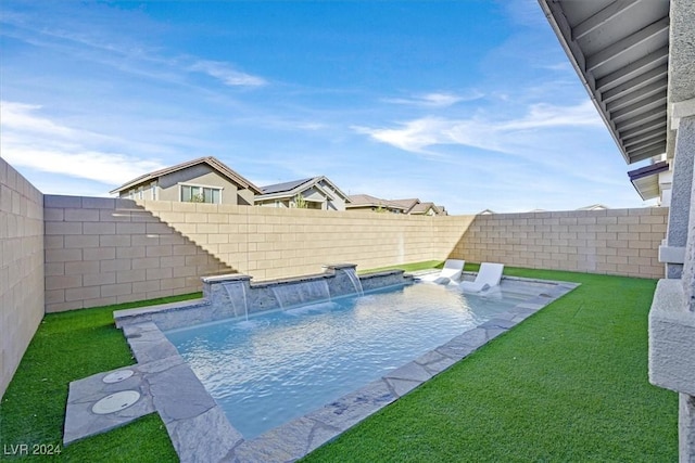 view of swimming pool featuring pool water feature and a yard