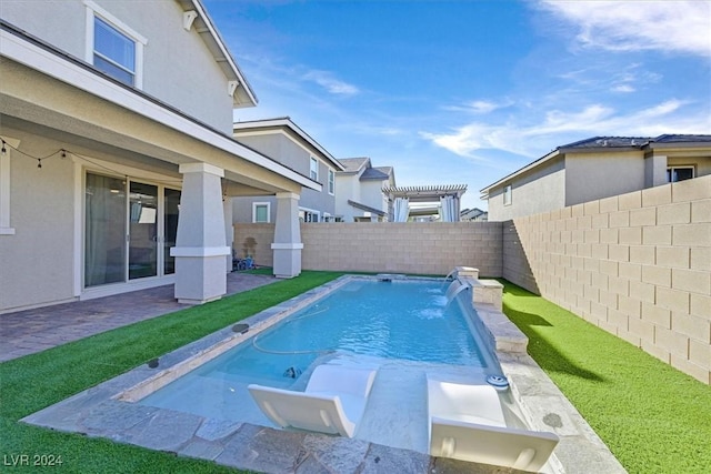 view of swimming pool featuring pool water feature and a pergola