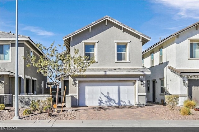 view of property featuring a garage and cooling unit