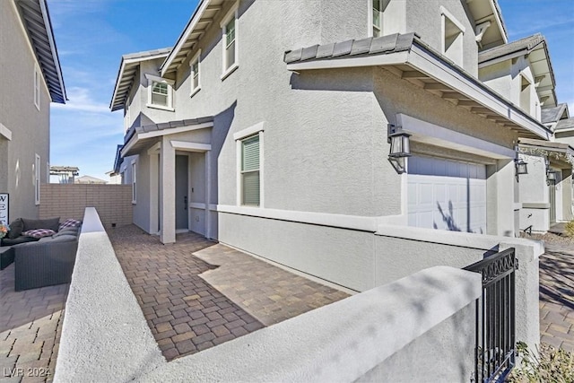 view of side of home featuring a garage