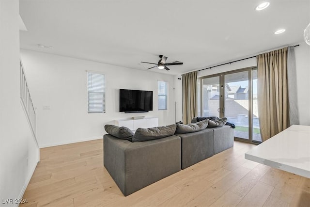 living room featuring ceiling fan and light hardwood / wood-style floors