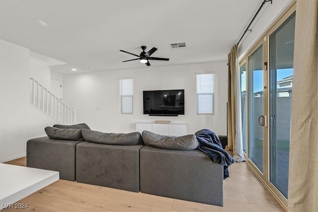 living room with ceiling fan and light hardwood / wood-style floors