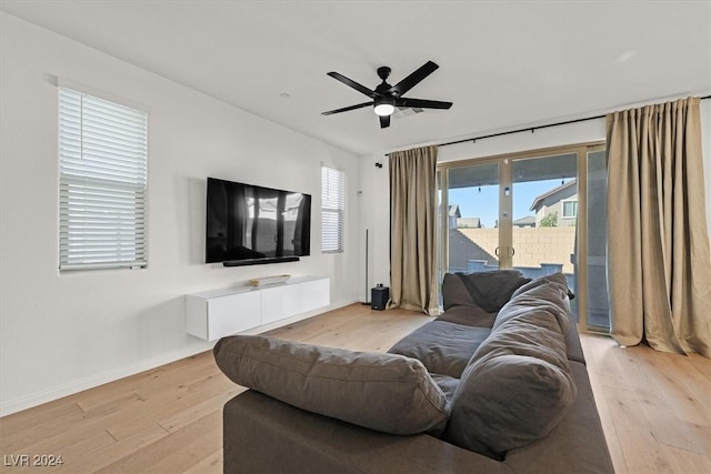 living room featuring ceiling fan and light wood-type flooring