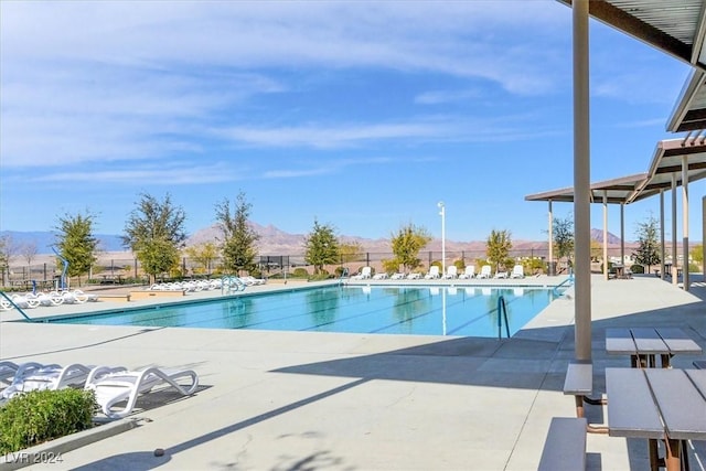 view of pool featuring a mountain view and a patio area