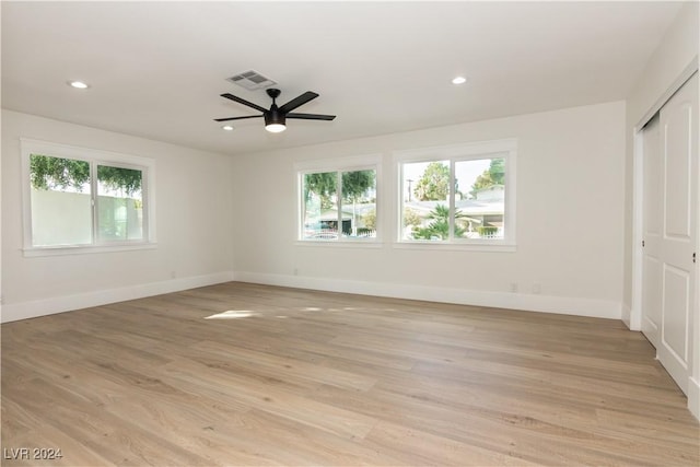 unfurnished bedroom with ceiling fan, a closet, and light wood-type flooring