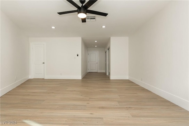 empty room with ceiling fan and light wood-type flooring