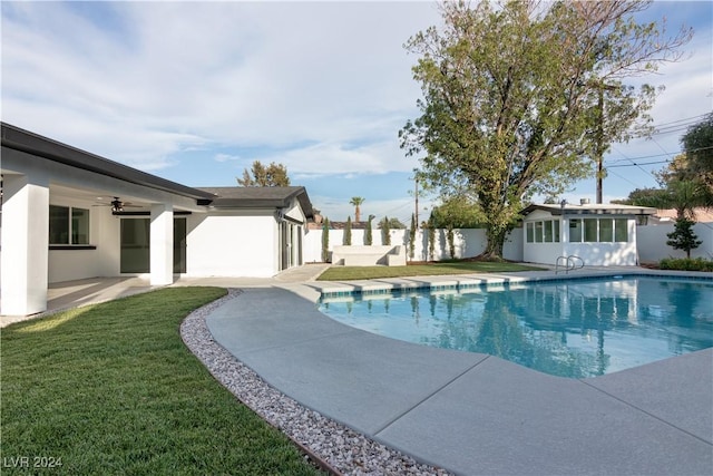 view of pool with a lawn, ceiling fan, and a patio