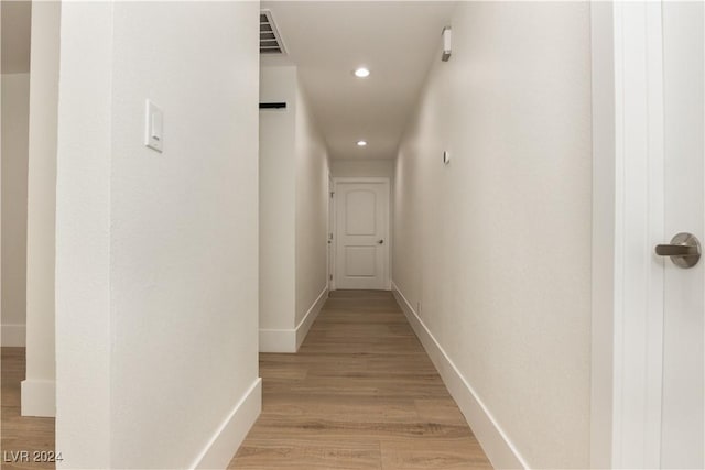 corridor with light hardwood / wood-style flooring