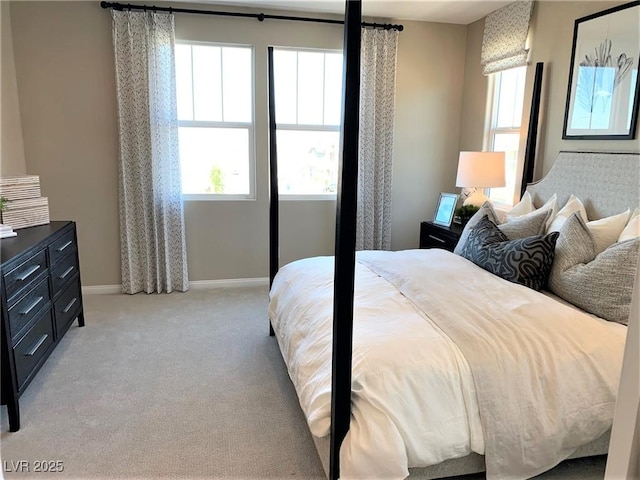 carpeted bedroom featuring multiple windows