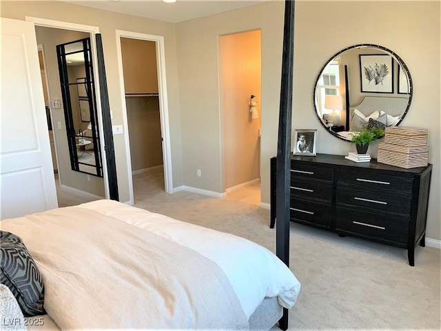 carpeted bedroom with a walk in closet and a closet