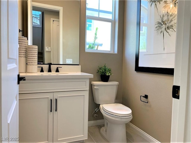 bathroom with tile patterned floors, vanity, and toilet