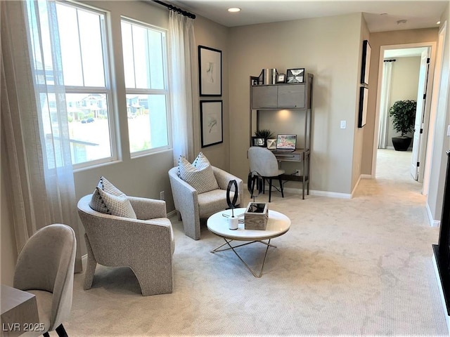 sitting room featuring a healthy amount of sunlight and light colored carpet