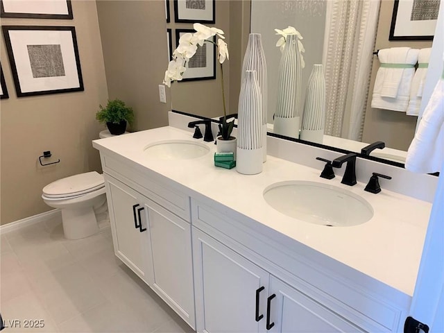 bathroom featuring tile patterned flooring, vanity, and toilet