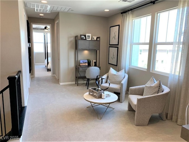 sitting room featuring ceiling fan and light colored carpet