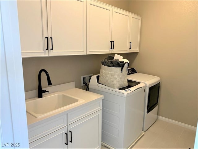 clothes washing area with cabinets, light tile patterned floors, separate washer and dryer, and sink