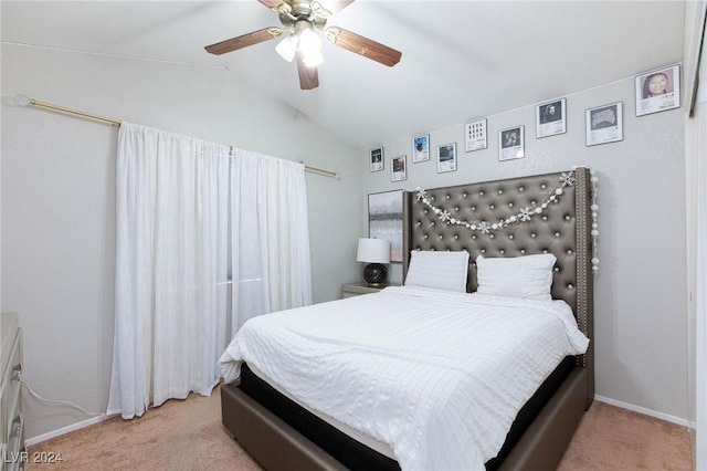 bedroom featuring light colored carpet, vaulted ceiling, and ceiling fan