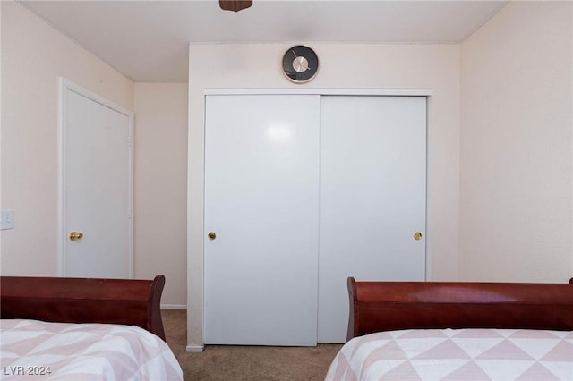 bedroom featuring a closet and light colored carpet