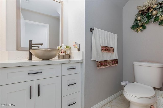 bathroom featuring tile patterned floors, vanity, and toilet