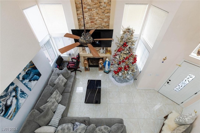 living room with a high ceiling and ceiling fan