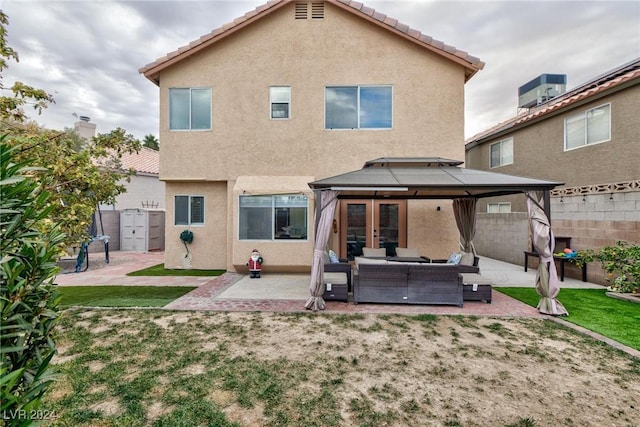 rear view of house with outdoor lounge area, french doors, cooling unit, a gazebo, and a patio