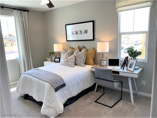 carpeted bedroom with ceiling fan and multiple windows