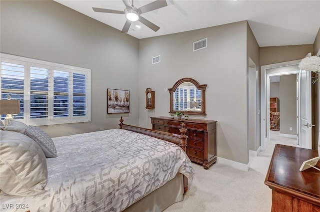 bedroom with light carpet, vaulted ceiling, and ceiling fan