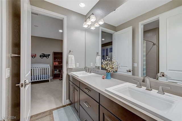 bathroom with recessed lighting, visible vents, a sink, and double vanity