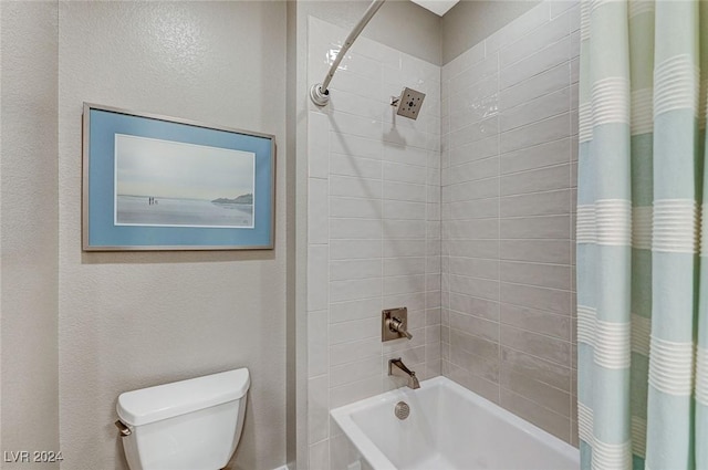 bathroom featuring toilet and shower / bath combo with shower curtain