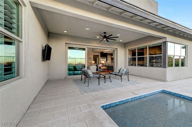 view of patio with ceiling fan and an outdoor pool