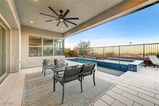 view of patio featuring ceiling fan and a pool with hot tub